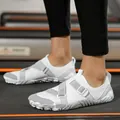 White and grey breathable outdoor water shoes with an adjustable strap on model's feet - 25 / White