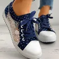 Close-up of navy blue polka dot sneakers with floral lace mesh and flower charm - 35 / Dark Blue