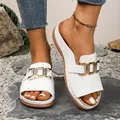 Comfortable white wedge platform sandals with gold buckles shown on feet over natural stones - 36 / White