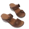 Detailed view of brown wedge slippers with laser-cut patterns and decorative flowers - 35 / Brown