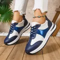 Detailed view of stylish blue and white color-blocked women's platform sneakers worn on wood - 36 / Blue