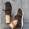 Close-up of brown fly-knit women's casual sneakers with lace-up design on grey tile - 35 / Dark Brown