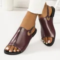 Detail view of burgundy flat sandals with gold ring buckle and white stitching - Burgundy