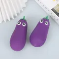 Two purple eggplant stress relief toys with cute cartoon eyes on a light blue background. - Purple