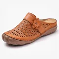 Detailed view of a tan laser-cut leather clog featuring a stylish floral ornament - 35 / Yellow