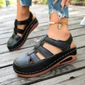 Detail view of women's black closed-toe wedge sandals with hollow-out design - 36 / Black