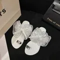 Elegant white flat sandals featuring oversized sheer bows and rhinestone toe loops - 35 / White