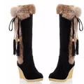 Side detail of black suede-like snow boots with brown faux fur trim and tassels. - 35 / Black