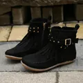 Close-up of black fringe ankle boots with golden rivets and decorative buckle strap - 36 / Black