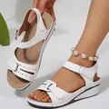 Detailed view of women's white peep-toe wedge sandals with hollow design and velcro straps - 36 / White