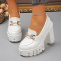 Close-up of white platform chunky heels with gold buckle and rivet details for a gothic look - 38 / White