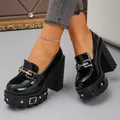 Detail view of black patent leather platform loafers with punk gothic rivets and metal buckles. - 36 / Black