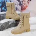 Close-up side view of beige lace-up Martin boots with buckle strap detail in snow - 35 / Brown