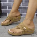 Close-up of women's wedge thong sandals with hollow out design and metal buckle detail. - 36 / Yellow