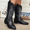 Detailed view of black women's cowboy boots with white wing embroidery and pointed toe - 36 / Black