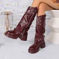 Detailed view of burgundy slouchy platform knee-high boots with stylish side zipper - Red