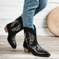 Close-up of black western boots with intricate embroidery and vintage chunky heels. - 36 / Black