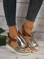 Detailed view of women's metallic gold platform sandals with rope trim and brown buckle straps. - 38 / Gold