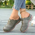 Close-up of green hollow-out closed-toe flat sandals with bow detail and laser-cut pattern. - 36 / Dark Green