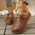 Brown vintage women's summer clogs featuring floral laser-cut details and a small bow - 36 / Dark Brown