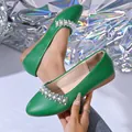 Detail view of green French flat shoe with sparkling rhinestone and pearl embellishments - 36 / Graphite