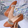 Close-up of brown French-style flat shoes featuring elegant pearl and rhinestone accents. - 36 / Silver Gray