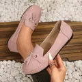 Detailed view of women's pink suede loafers featuring elegant tassels and decorative stitching - 38 / Pink