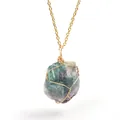 Close-up detail of a natural raw fluorite crystal pendant with handmade gold wire wrapping. - Green Fluorite (Wire Wrapped) / Gold