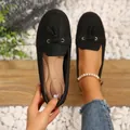 Zwarte damesloafers met kwastjes afgebeeld aan de voet en in de hand op witte kiezelstenen - 36 / Zwart