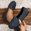 Close-up view of blue women's loafers featuring elegant tassels and handcrafted stitching - Navy Blue