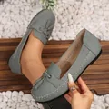 Grey ladies flat loafers with tassels and contrast stitching shown in a lifestyle view - 38 / Gray