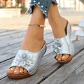 Stylish silver wedge sandals for women featuring elegant flower decoration and wood-textured sole - Silver