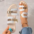 Detailed view of women's wedge sandals with silver glitter and gold metallic straps. - 35 / Silver