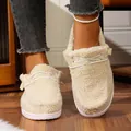 Detail view of cozy cream fuzzy winter slippers with stylish white decorative laces - Off White