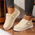 Close-up of women's cozy fleece loafers with thick soles worn on wooden floor. - Off White