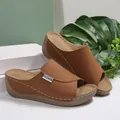 Close-up of stylish brown wedge peep toe sandals with elegant white stitching details - 36 / Brown