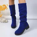 Detailed view of women's bright blue suede slouchy boots featuring a stylish chunky heel - 35 / Blue