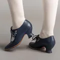 Close-up of vintage navy blue lace-up high heels with elegant hollow-out pattern details. - 35 / Dark Blue