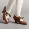 Close-up of vintage brown leather lace-up high heels with cutout details on white socks - 35 / Dark Brown