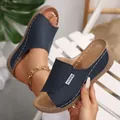 Close-up of navy blue wedge sandals with peep toe and platform sole. - 36 / Navy Blue