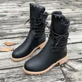 Detail of black mid-calf boots featuring metal rivets and wrapped lace-up design - 36 / Vintage Black
