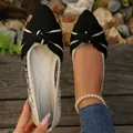 Detailed view of pointed toe knit flats with a striped bow and textured fabric - 36 / Black