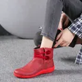 Detailed side view of red retro leather short boots with decorative buttons. - 38 / Red