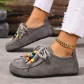 Close-up of retro grey suede slip-on shoes featuring colorful decorative beads on the laces - 36 / Gray