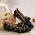 Vue détaillée de chaussures plates en tricot noir à bout pointu avec un élégant nœud beige - Trèfle Noir