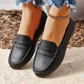 Macro view of black leather flat loafers featuring textured finish and neat stitching - 36 / Black