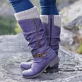 Close-up detail of stylish purple mid-calf boots featuring knit cuffs and buckle strap - Purple