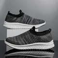 Grey fly-knit slip-on sneakers with breathable mesh and white wavy sole for running - 39 / Grayish White