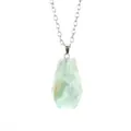 Detailed close-up of a natural green fluorite coffin pendant necklace with silver chain - Fluorite