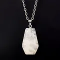 Macro view of a natural white crystal pendant in a miniature coffin shape with silver chain - White Crystal